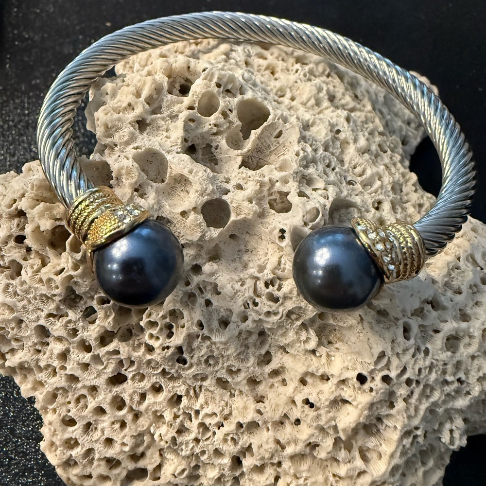 Silver and Gold open twisted bangle with dark grey pearls and zirconia stones.